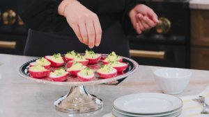 sprinkling garnish on top of eggs