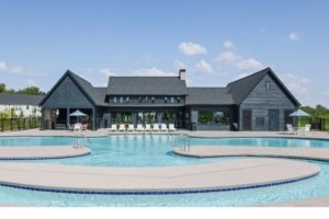 Dark blue pool house overlooking pool and lazy river
