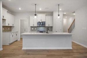 white cabinets and white counters of a kitchen and its island